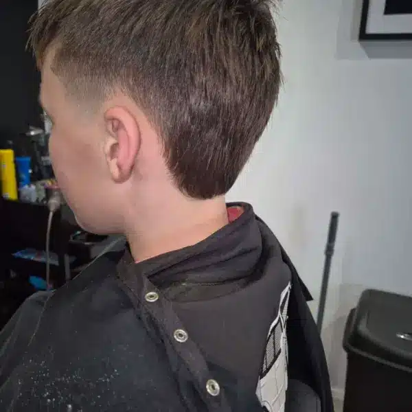 Boys skin fade with textured top, rear view