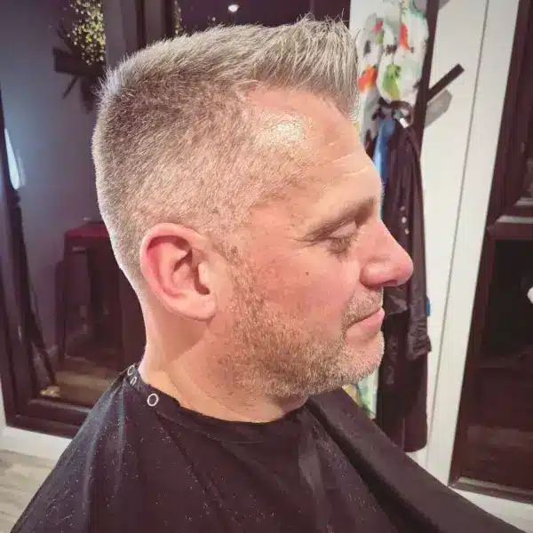 Gents short clipper cut with fade, front three-quarter view
