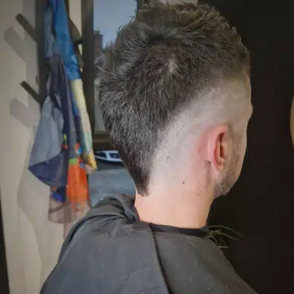 Boys low fade with natural top, side view